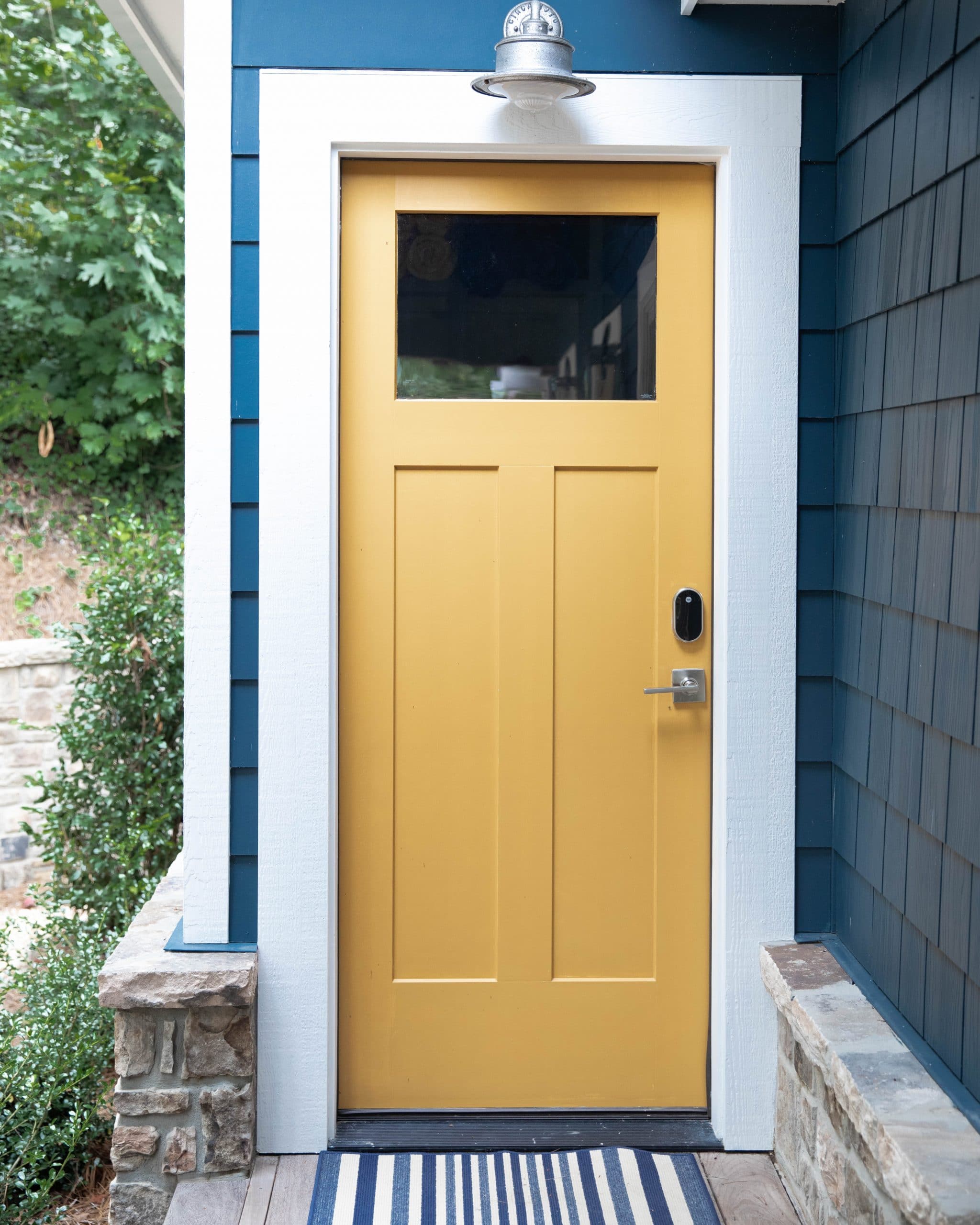 yellow doors for the blue and white lakehouse remodel with shiplap