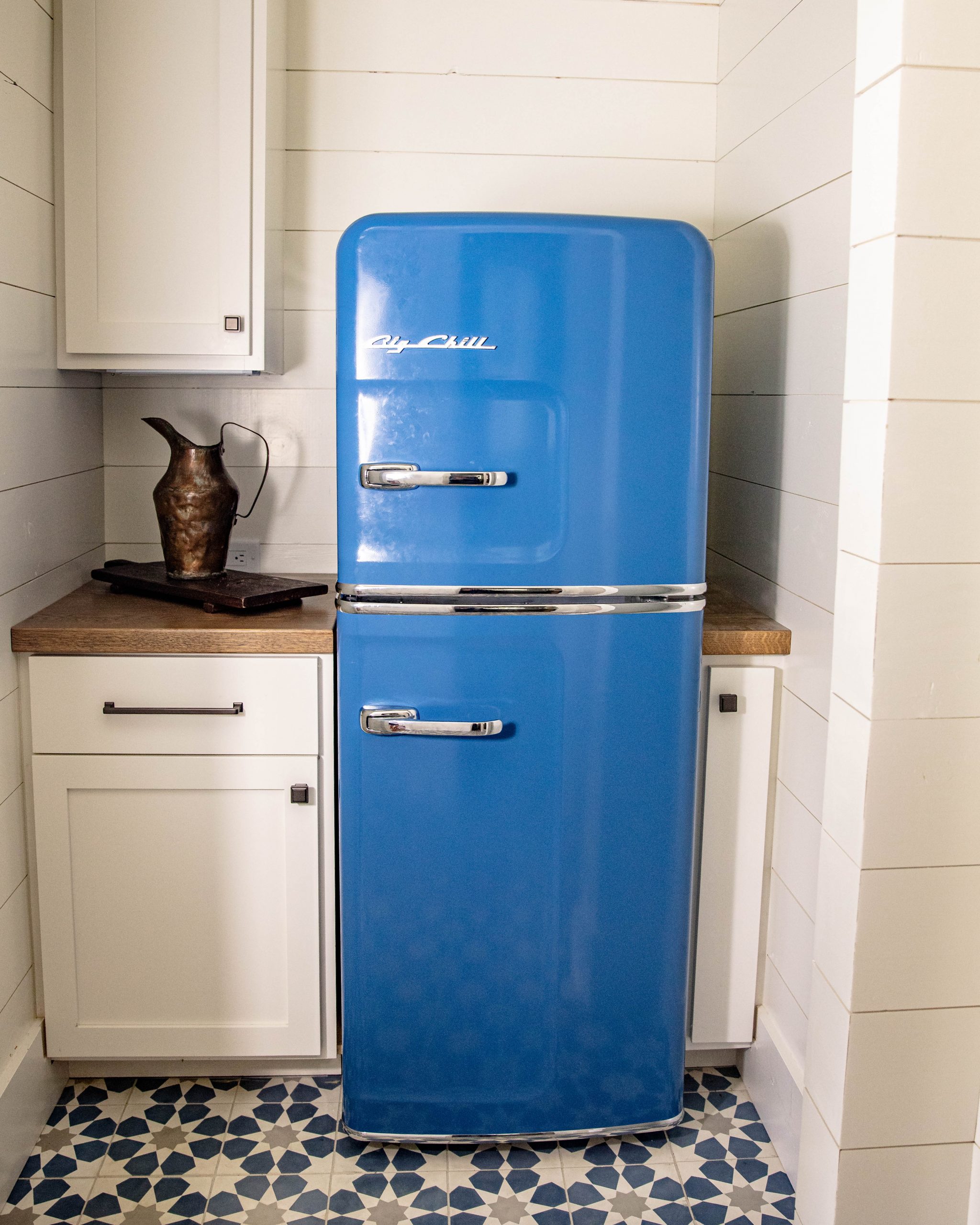 blue fridge in small white and blue secondary lakehouse kitchen
