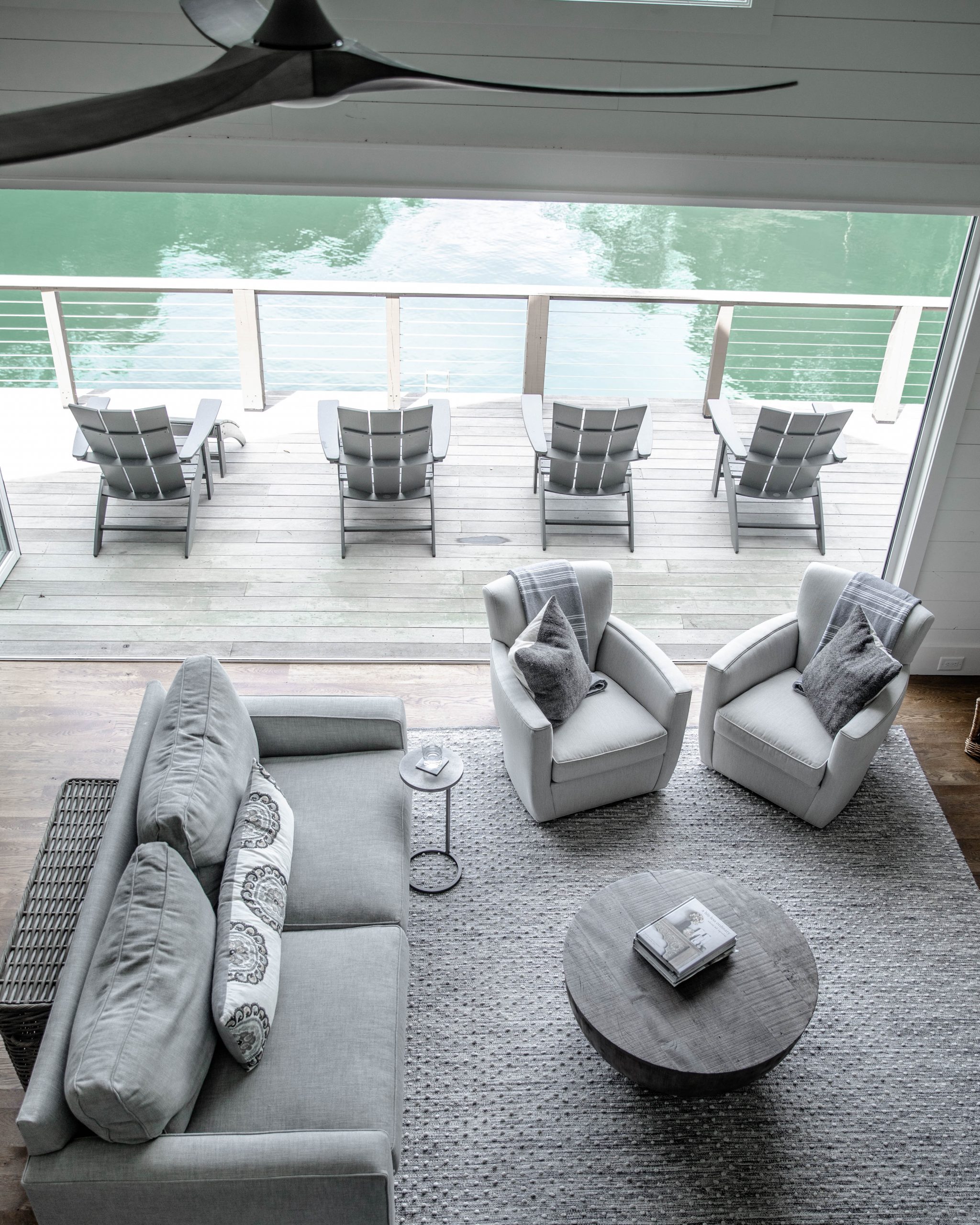 lakehouse aerial shot of deck chairs, patio and living room
